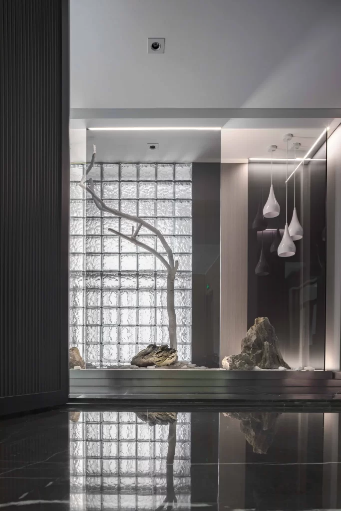 Contemporary Minimalist Interior Neutral Tones Glass Block Wall Reflective Floor Artistic Decor