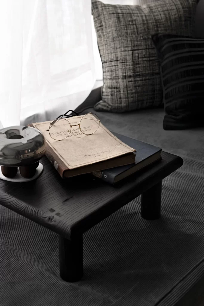 Cozy Reading Nook Dark Textured Cushions Rustic Table Neutral Tones