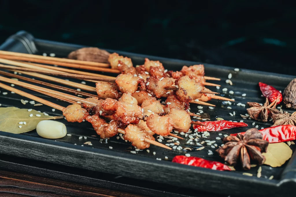Crispy Pork Skewers Spicy Sauce Golden Brown Garnish
