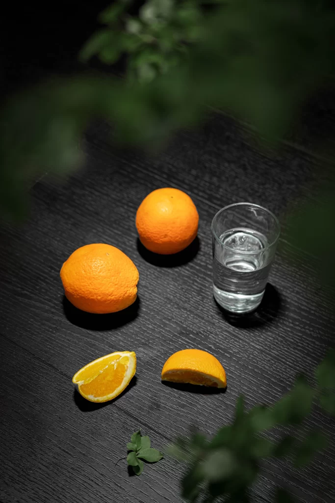 Dark Wood Table Oranges Glass Water