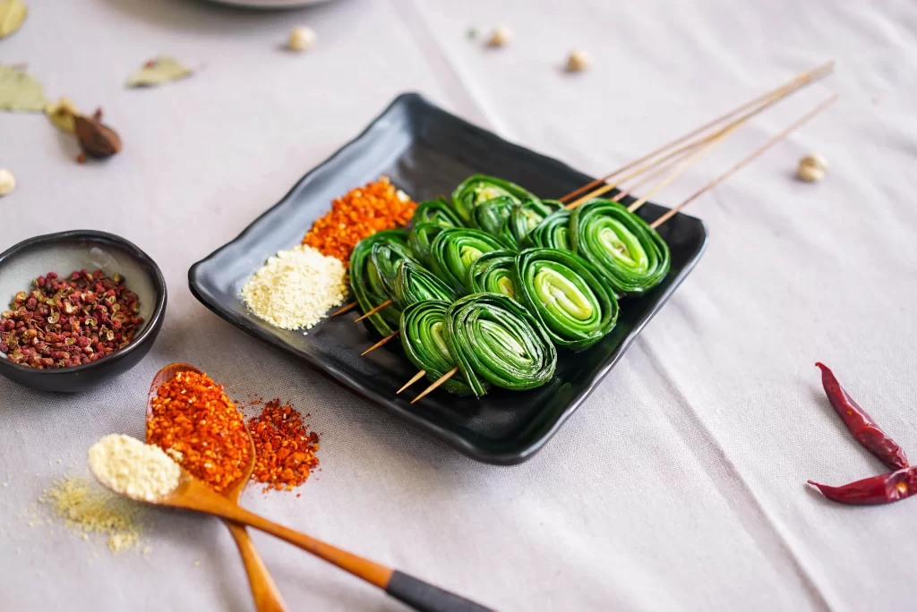 Fresh Green Onion Skewers Spices Garnish Black Plate