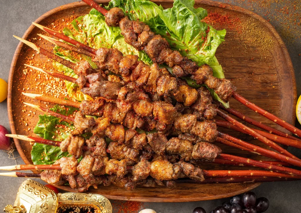Golden Brown Beef Skewers on Rustic Wooden Plate with Garnish