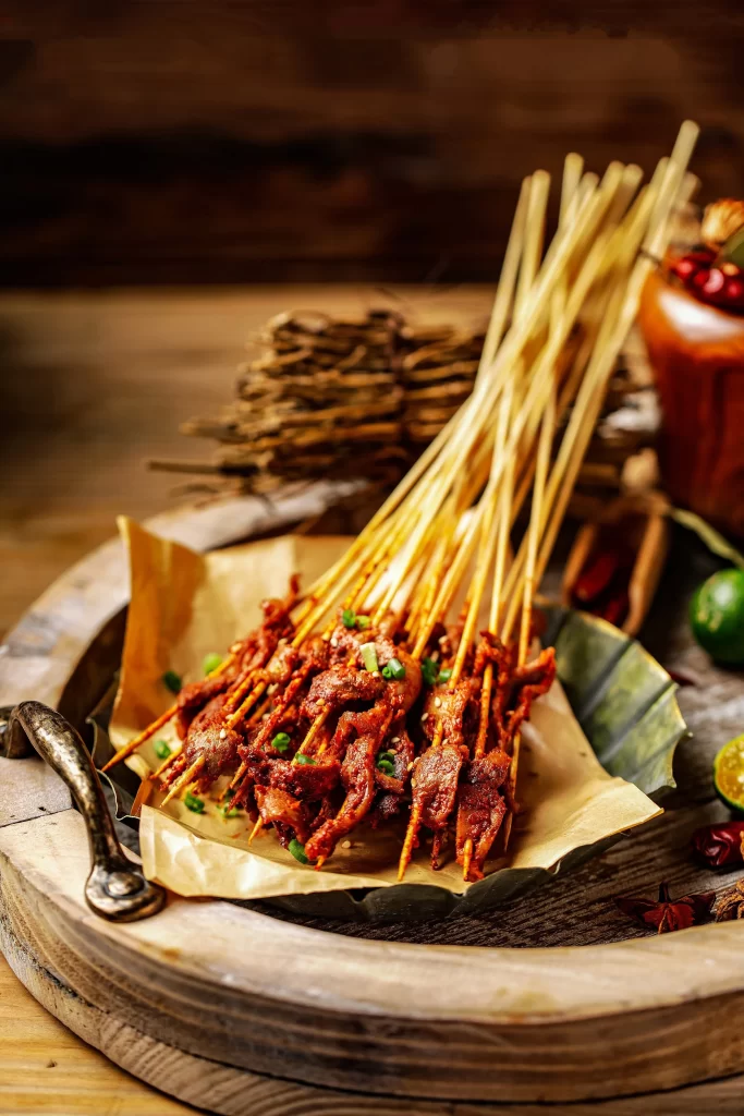 Golden Brown Beef Skewers with Charred Edges on Rustic Tray