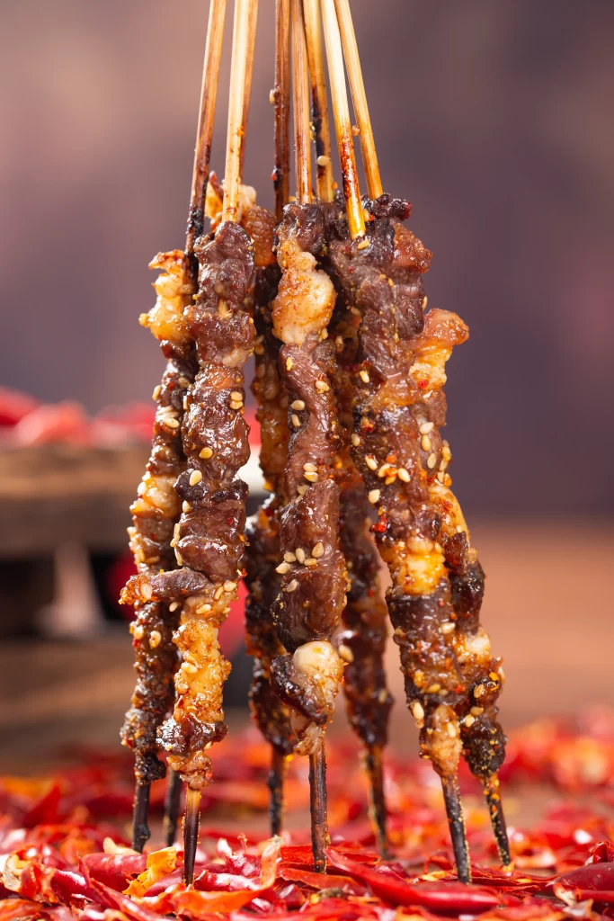 Golden Brown Beef Skewers with Crispy Char and Reddish Garnish