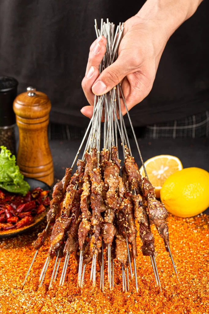 Golden Brown Beef Skewers with Sesame and Lemon Garnish