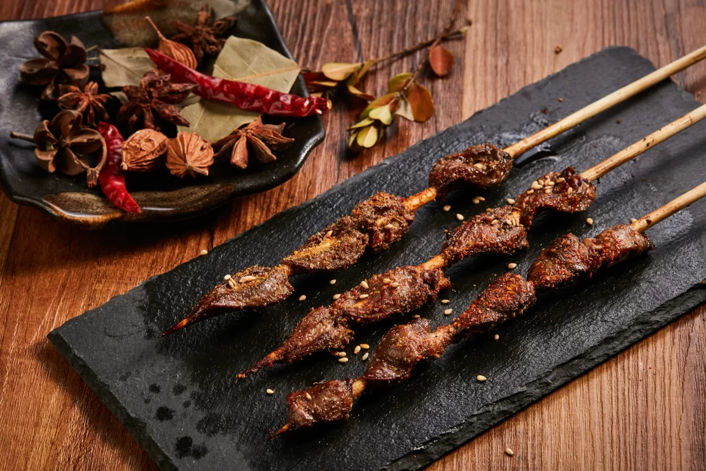 Golden Brown Beef Skewers with Sesame on Slate Plate