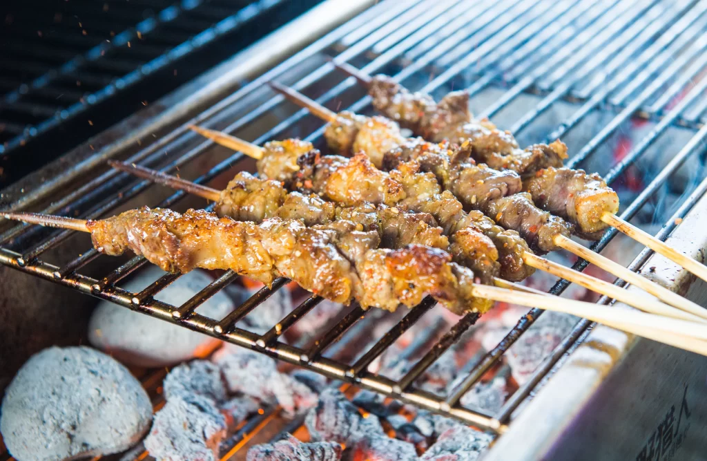 Golden Brown Chicken Skewers Sizzling on Charcoal Grill