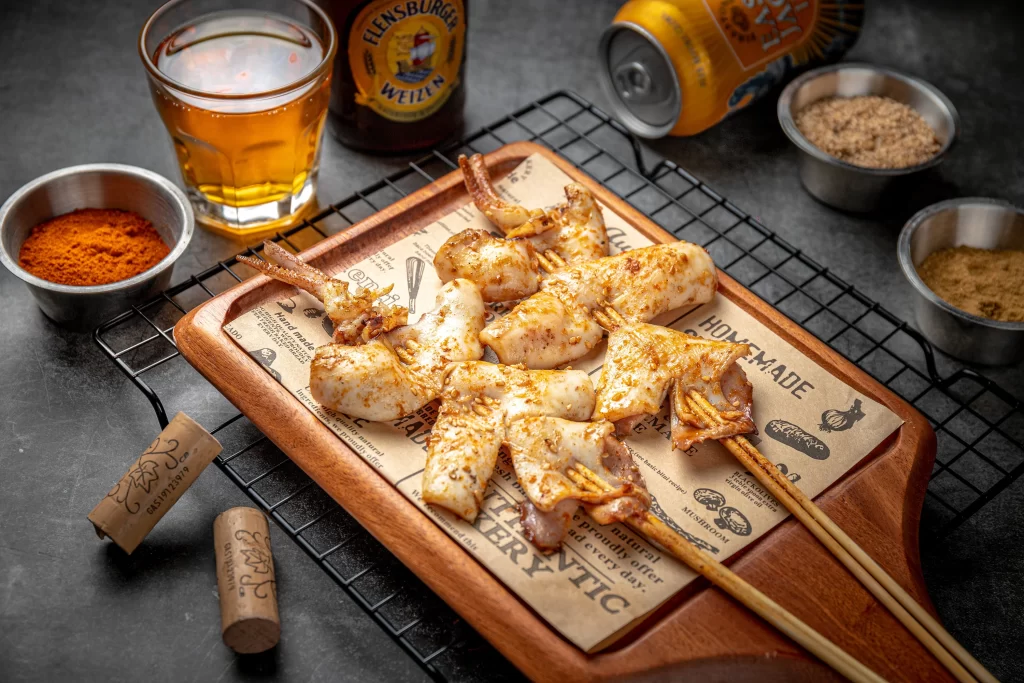 Golden Brown Chicken Skewers with Spices on Wooden Platter
