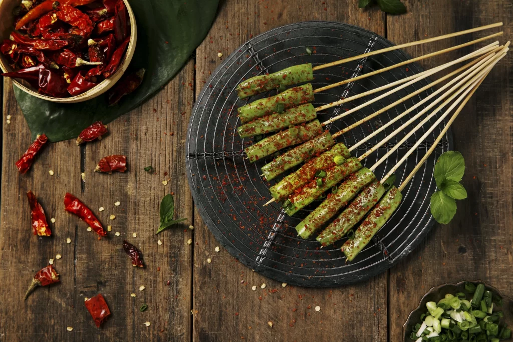 Golden Brown Grilled Asparagus with Reddish Spices on Black Plate
