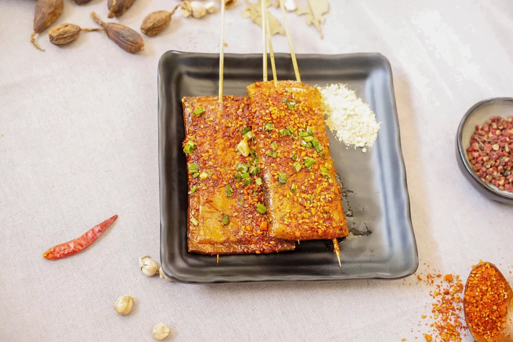 Golden Brown Grilled Tofu with Vibrant Red Pepper Garnish