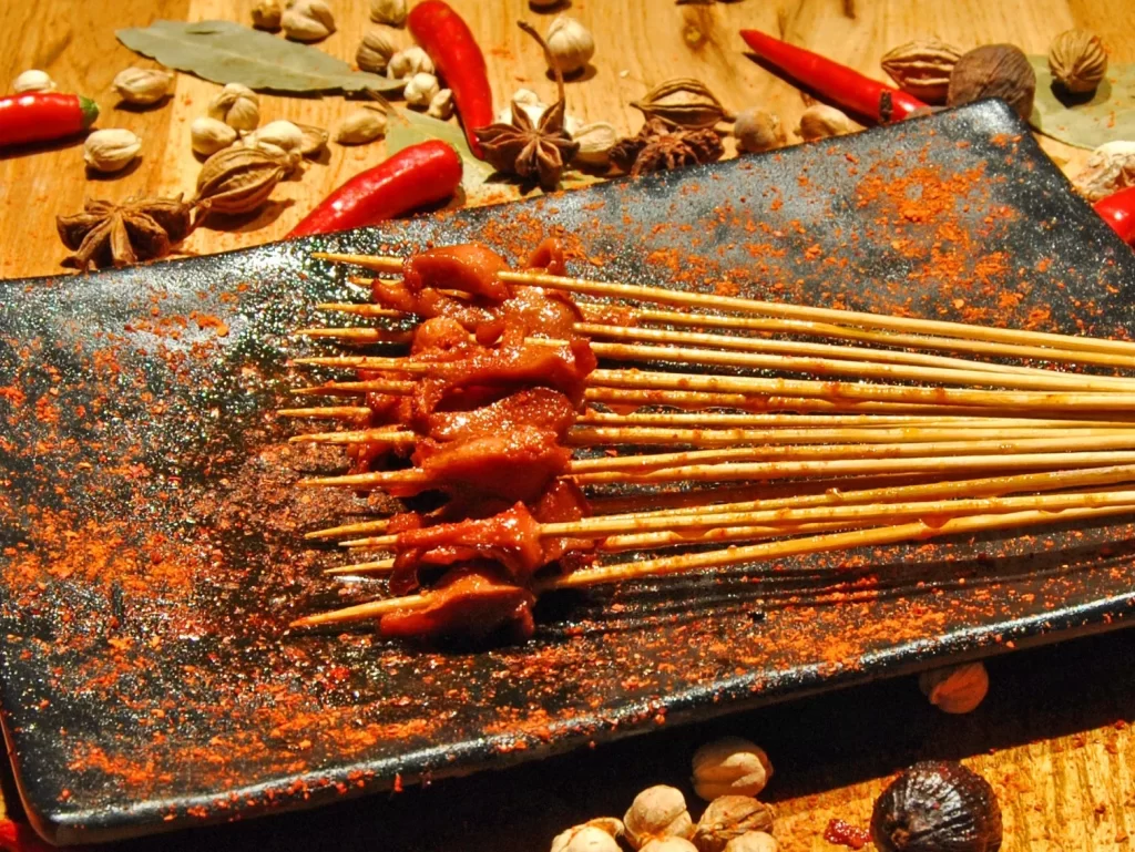 Golden Brown Pork Skewers on Black Rectangular Plate (48).JP