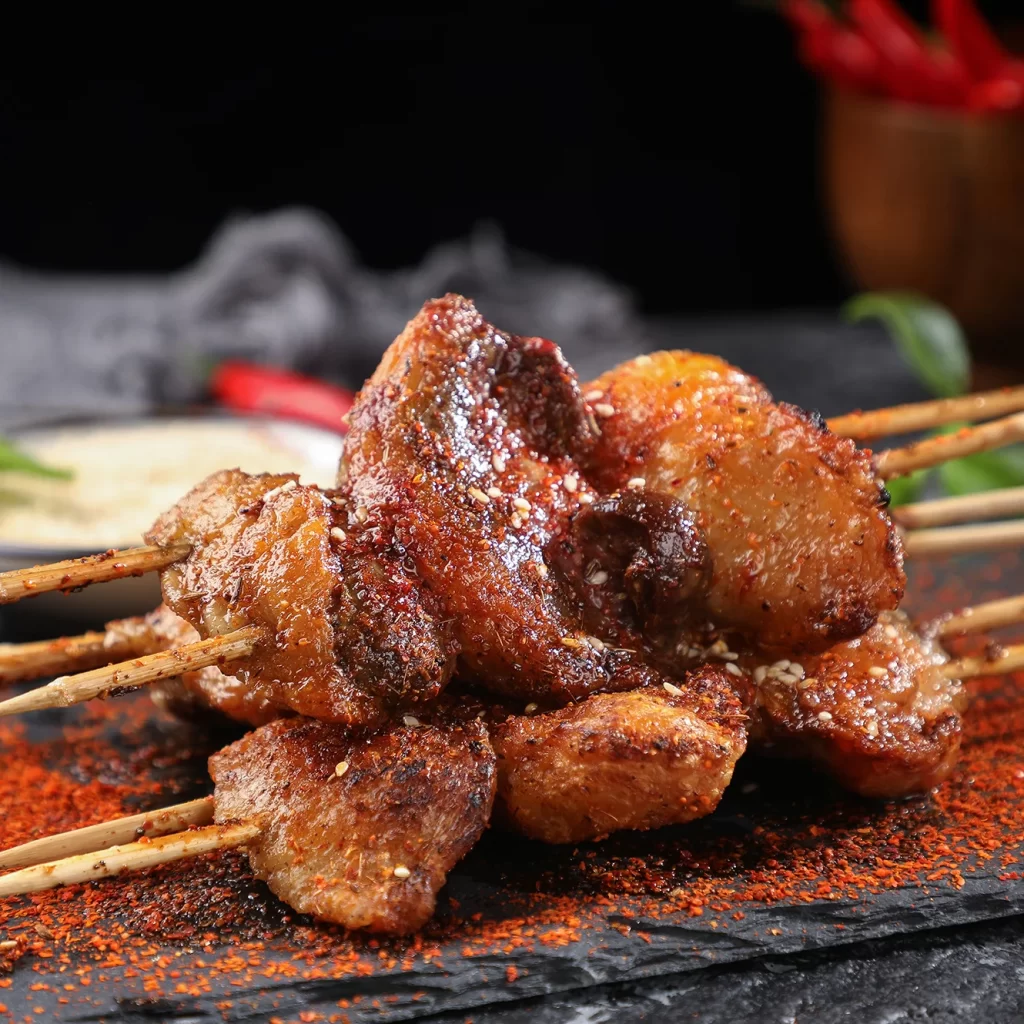 Golden Brown Pork Skewers with Charred Edges and Reddish Spices