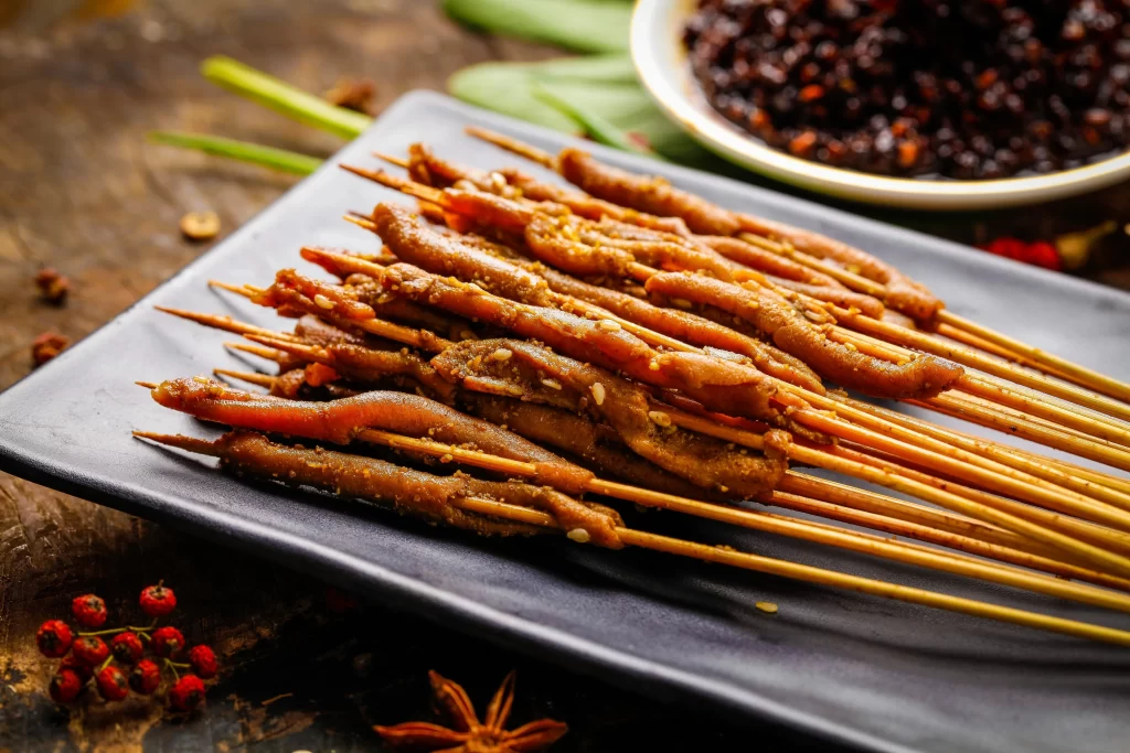 Golden Brown Pork Skewers with Crispy Char and Garnish