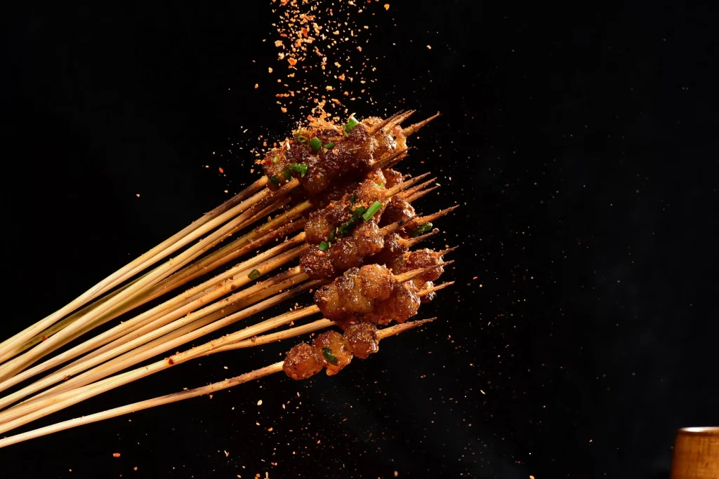 Golden Brown Pork Skewers with Fresh Green Onions and Spices