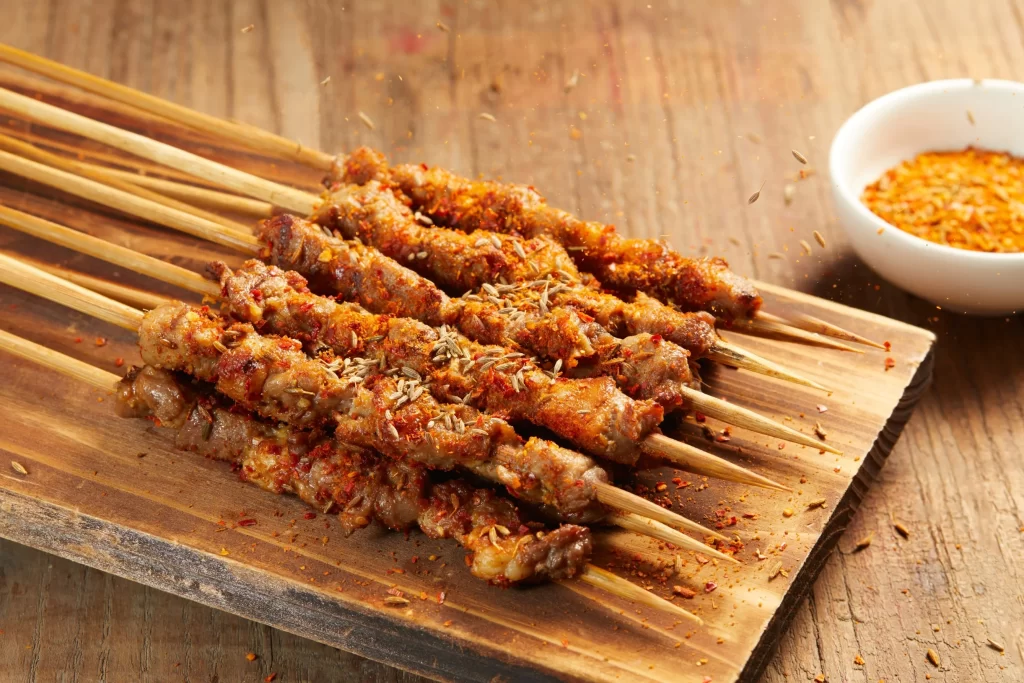 Golden Brown Pork Skewers with Reddish Spices on Wooden Plank 十一月(7).