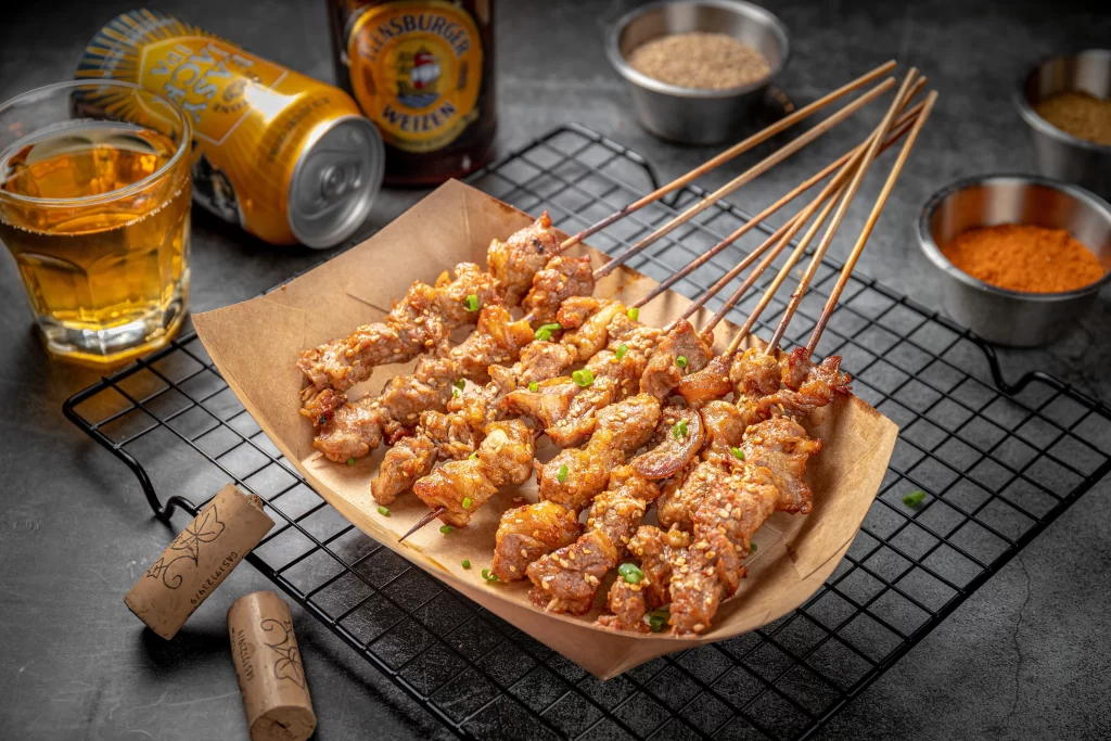 Golden Brown Pork Skewers with Sesame and Green Onions