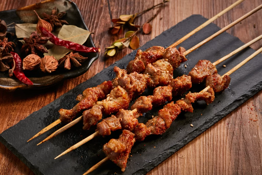 Golden Brown Pork Skewers with Sesame on Slate Plate ..JPG