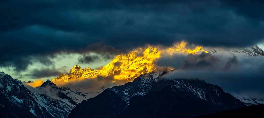 golden hour dramatic snow-capped rugged clouds serene majestic