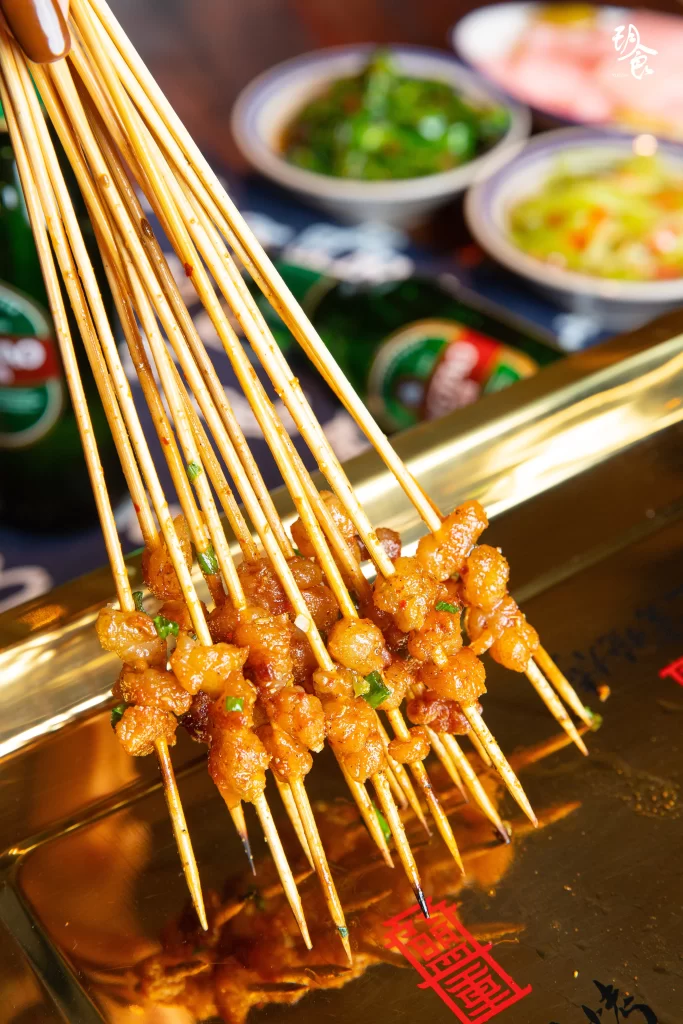 Golden Pork Skewers Charred Crust Green Onion Garnish