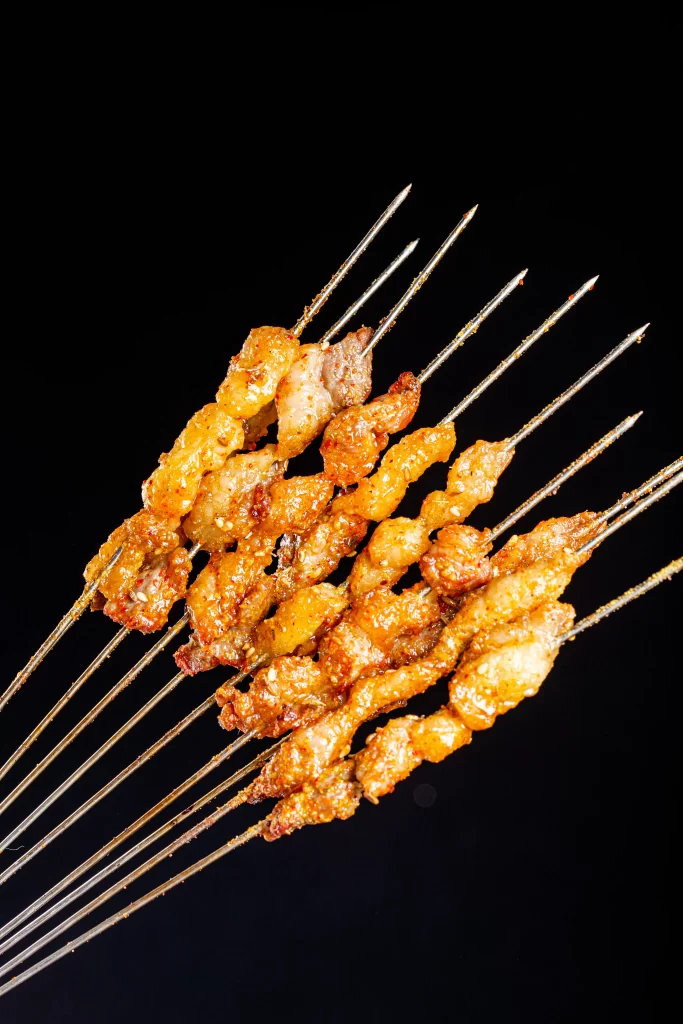 Golden Pork Skewers Charred Crust Spicy Seasoning Close Up