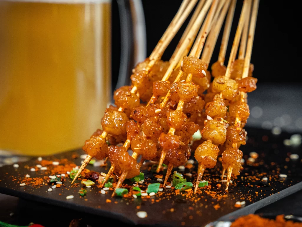 Golden Pork Skewers Spicy Sauce Crispy Char Garnish