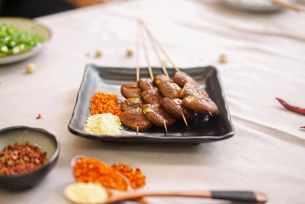 Grilled Beef Skewers Spicy Sauce Charred Edges Black Plate