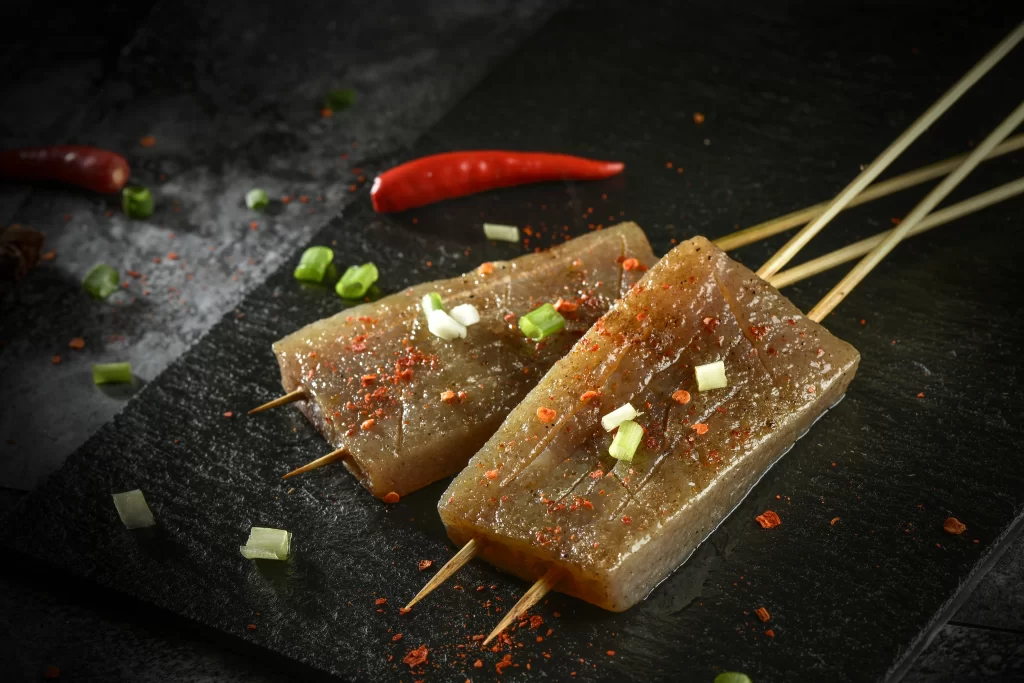 Grilled Beef Skewers Spicy Sauce Charred Edges Garnished