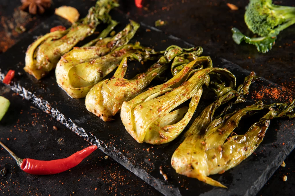 Grilled Bitter Melon Spicy Seasoning Charred Edges Black Slate