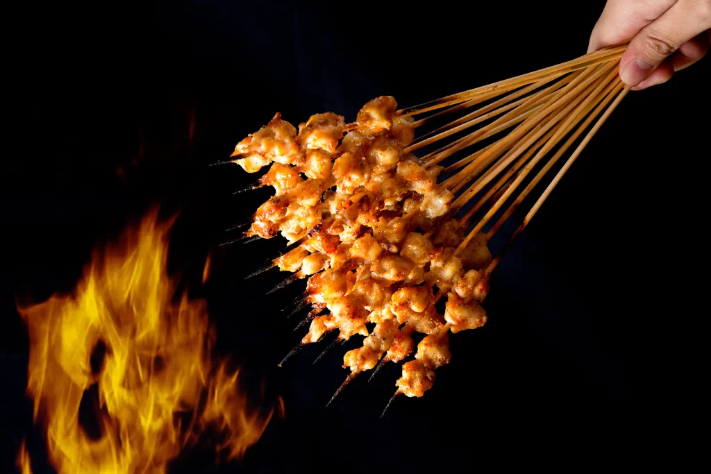 Grilled Chicken Skewers Charred Golden Brown Over Fire