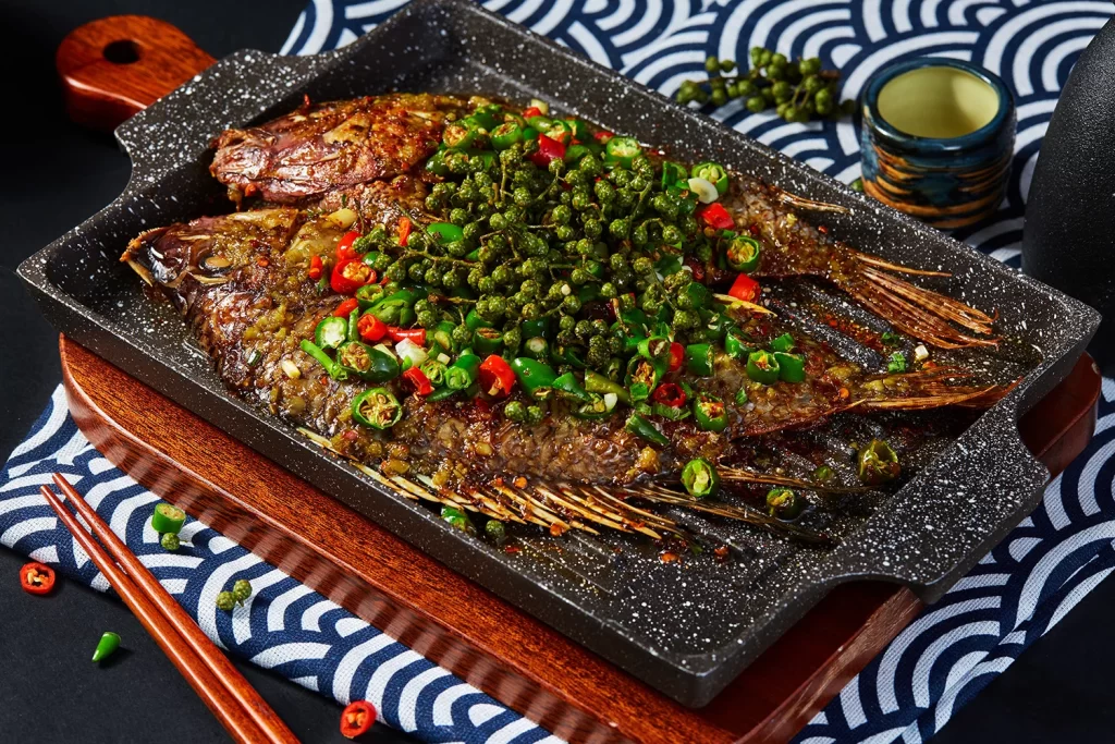 Grilled Fish with Spicy Pepper Garnish Black Plate