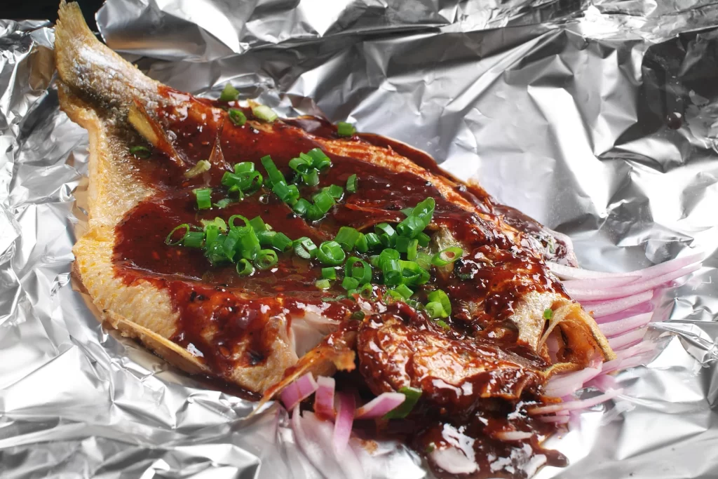 Grilled Fish with Spicy Sauce and Fresh Garnish