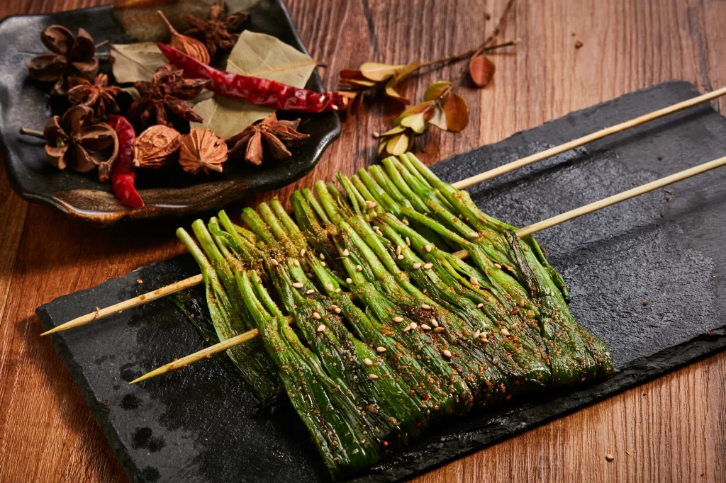 Grilled Green Onions Sesame Seeds Spicy Sauce Black Slate