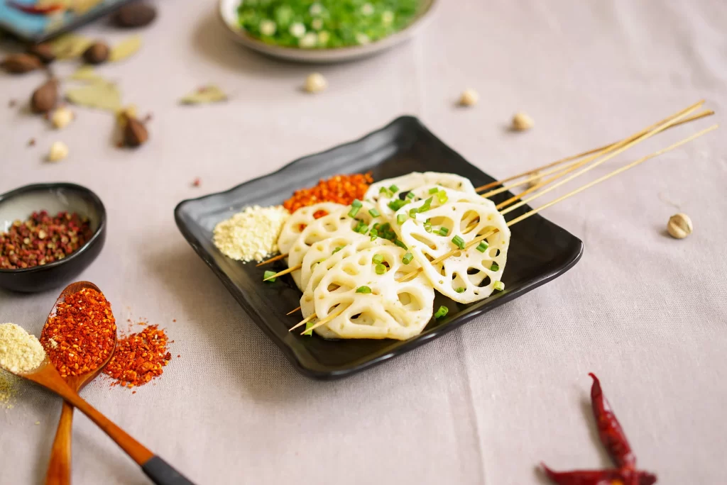 Grilled Lotus Root Skewers Green Onion Garnish Black Plate