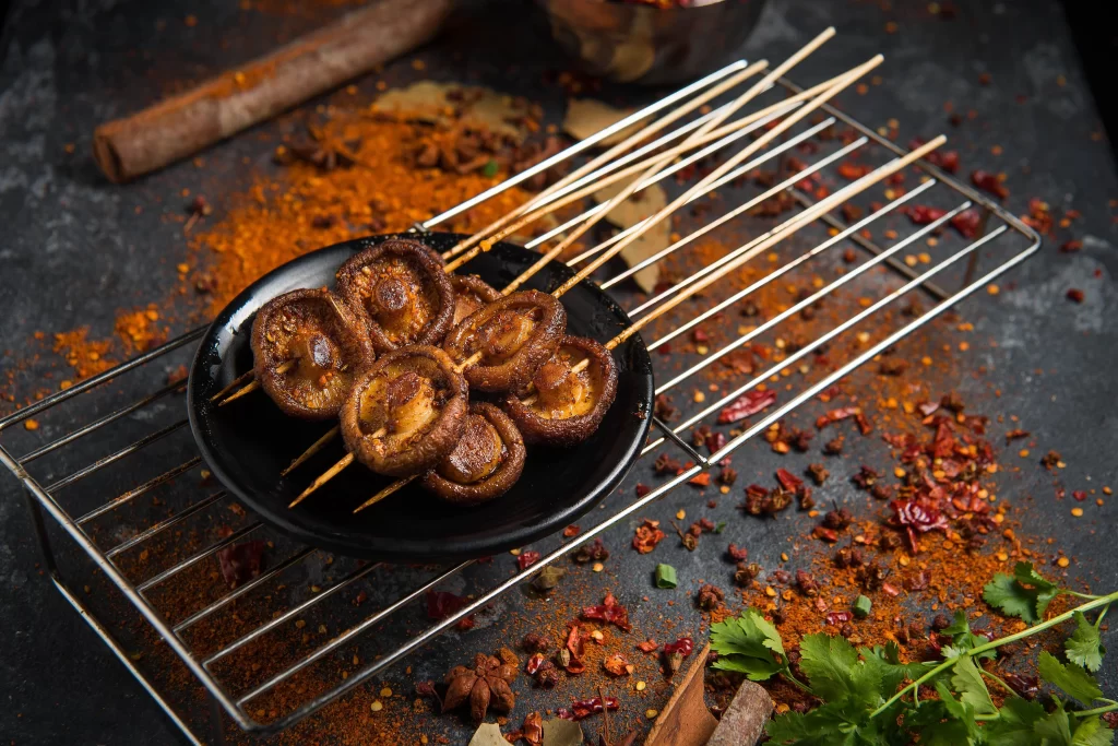 Grilled Mushroom Skewers Spicy Seasoning Charred Edges Black Plate