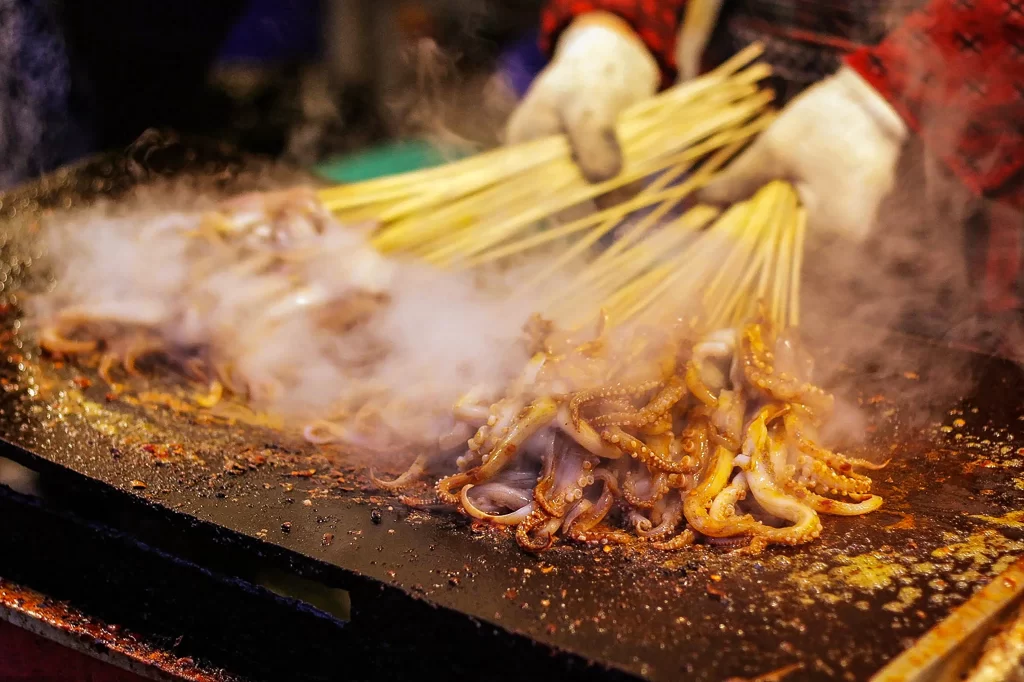 Grilled Octopus Skewers Golden Brown Smoke Rising