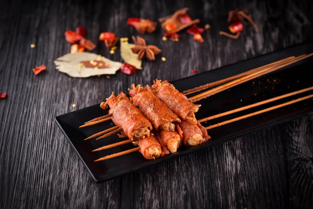 Grilled Pork Skewers Spicy Sauce Golden Crust Black Plate