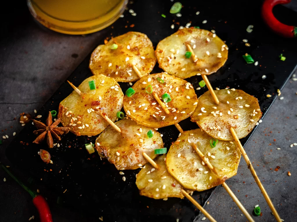 Grilled Potato Skewers Sesame Seeds Green Onion Garnish