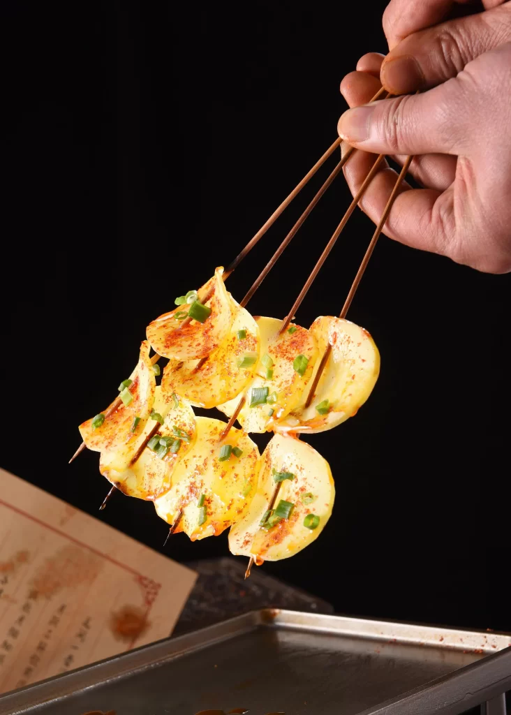Grilled Potato Slices Spicy Sauce Green Onion Garnish