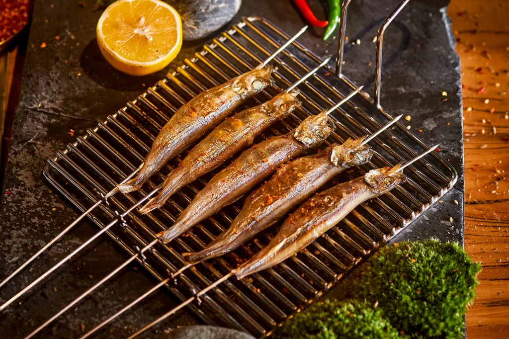 Grilled Sardines Spicy Sauce Charred Edges Fresh Lemon Garnish