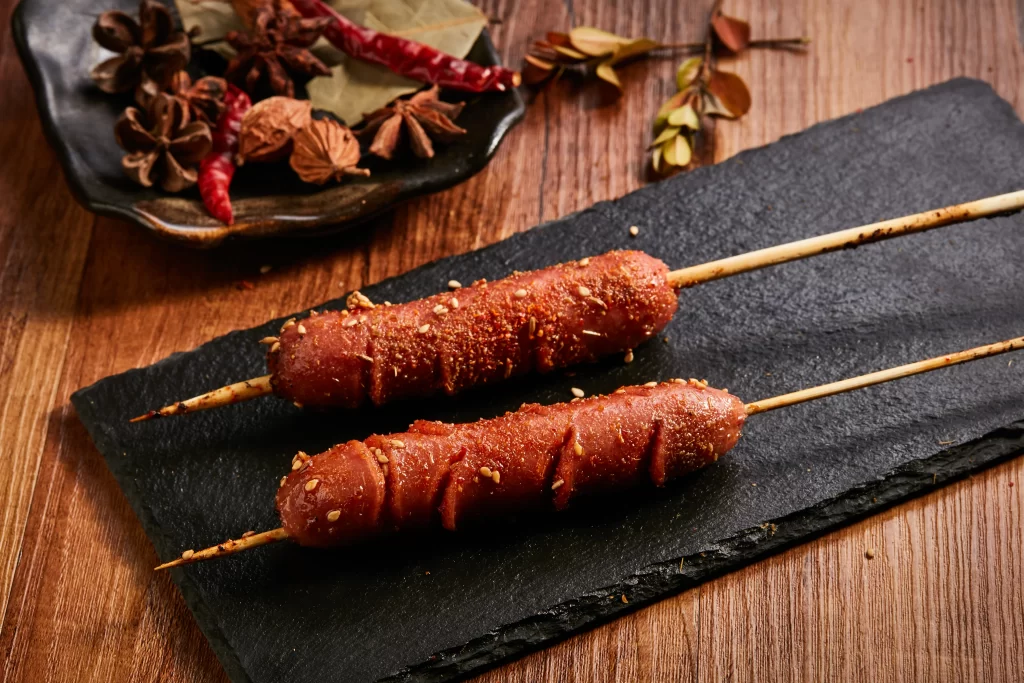 Grilled Sausage Skewers Spicy Seasoning Sesame Garnish Slate Plate