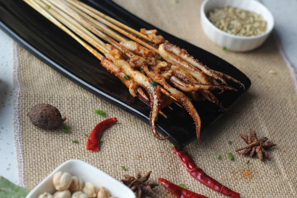 Grilled Squid Skewers Spicy Sauce Charred Tentacles Black Plate