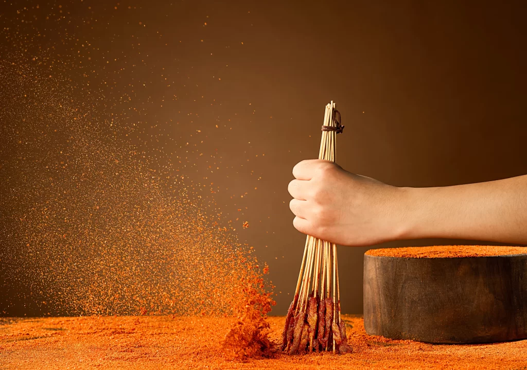 Hand Holding Skewers Spices Flying Golden Brown Crust