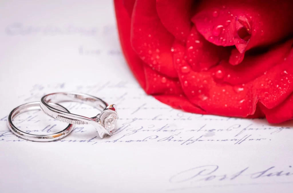 Red Rose Petals White Rings Blue Writing