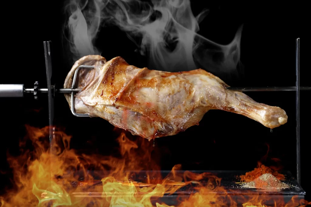 Rotisserie Lamb Leg Charred Golden Brown Smoke Rising