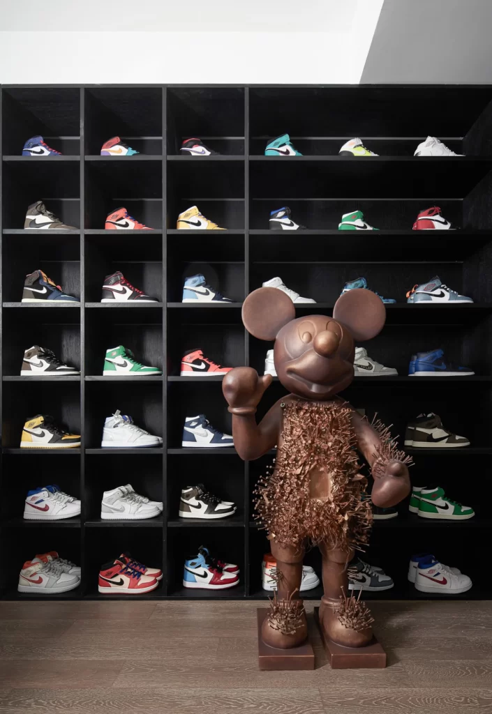 Shoe Collection Display Black Shelving Colorful Sneakers Bronze Sculpture