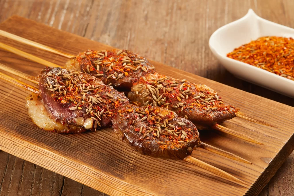 Spiced Lamb Skewers Cumin Red Pepper Garnish Wooden Board