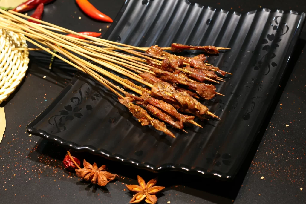 Spicy Beef Skewers Charred Crust Black Plate