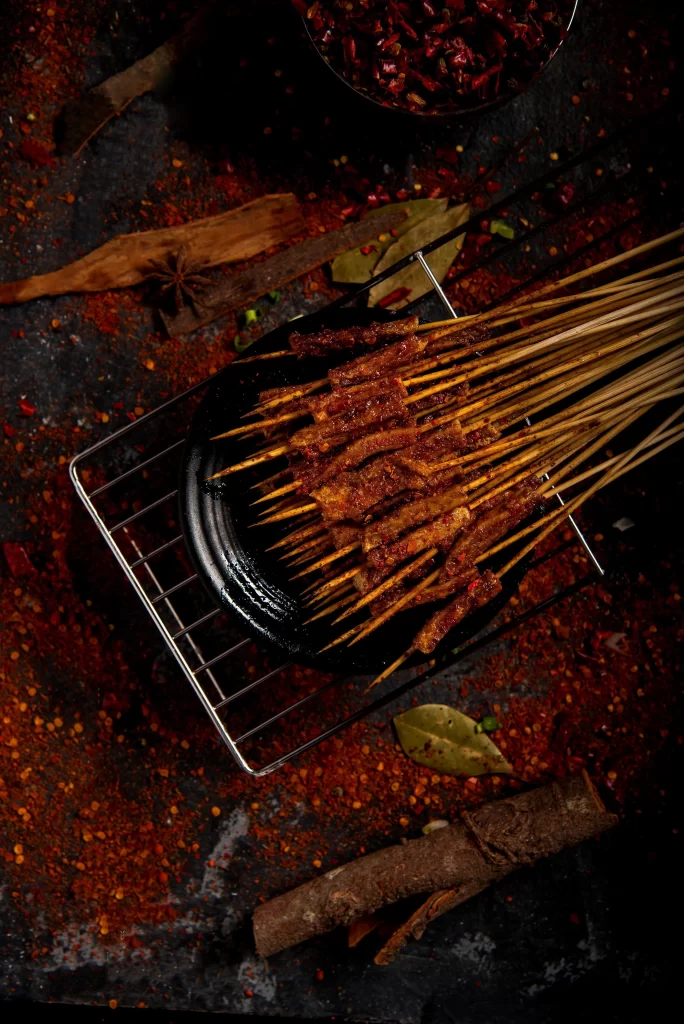 Spicy Beef Skewers Charred Crust Red Chili Flakes Garnish