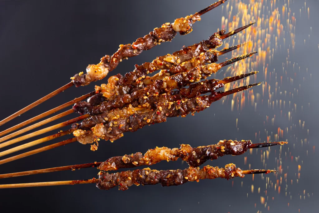Spicy Beef Skewers Charred Crust Sesame Seeds Close Up