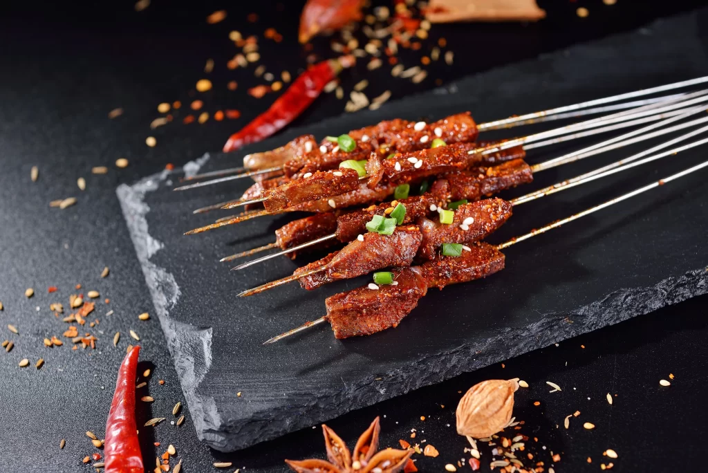 Spicy Beef Skewers Green Onion Garnish Black Slate Platter
